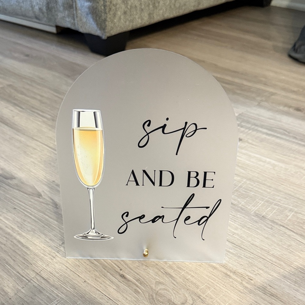 Sip and Be Seated Sign with Champagne Glass